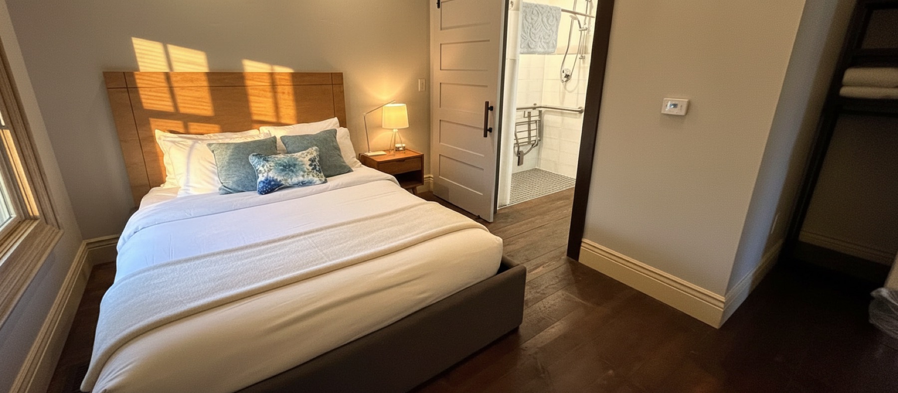 Accessible room with queen bed, barn door and roll-in shower